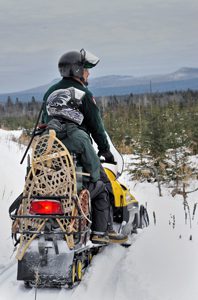 Registered Maine Guide on snowmobile